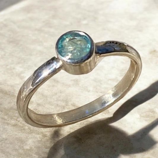 Transparent blue green Grandidierite gemstone from Madagascar displaying rare ocean coloured hues and natural inclusions.